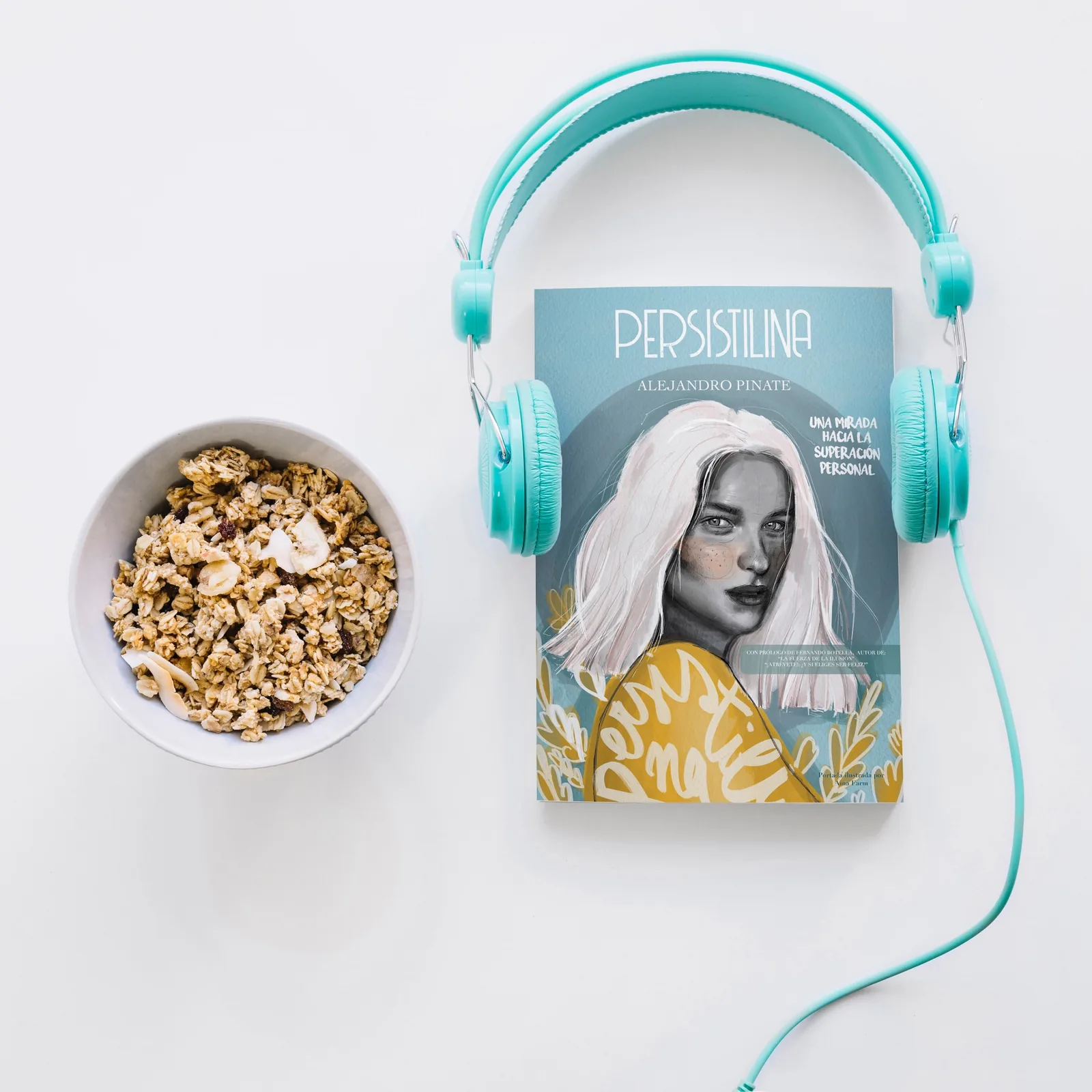 Libro Persistilina junto a unos auriculares